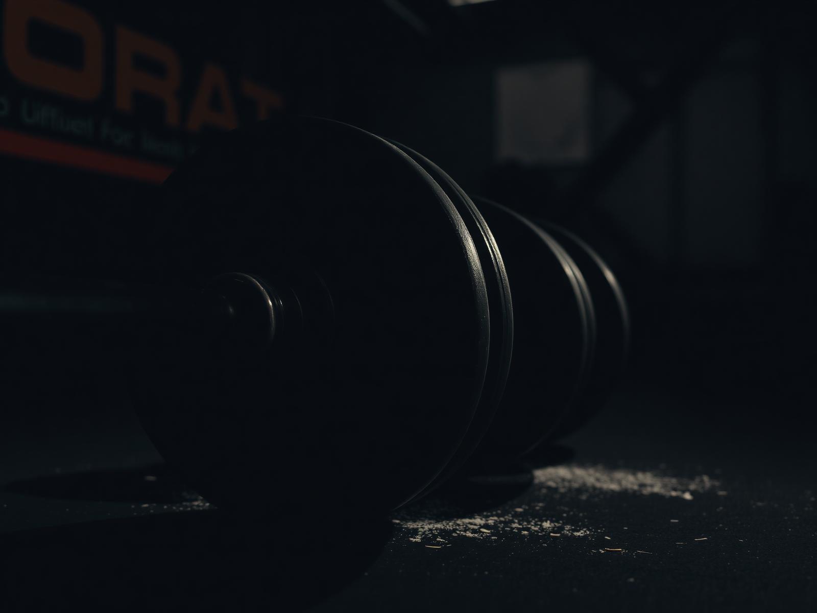 Loaded barbell in dim gym